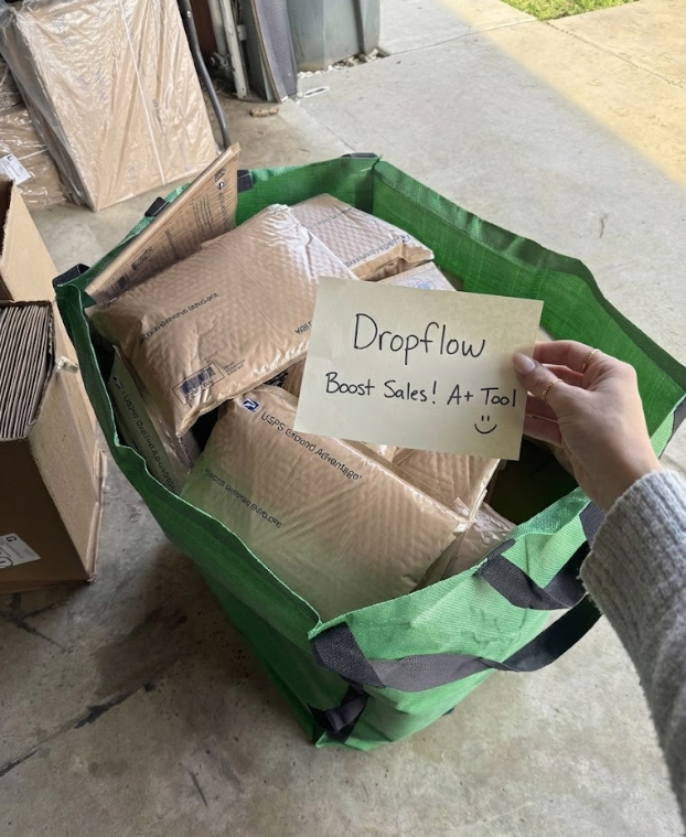 Green shipping bin filled with packages and a testimonial note confirming success with the DropFlow sales automation tool.